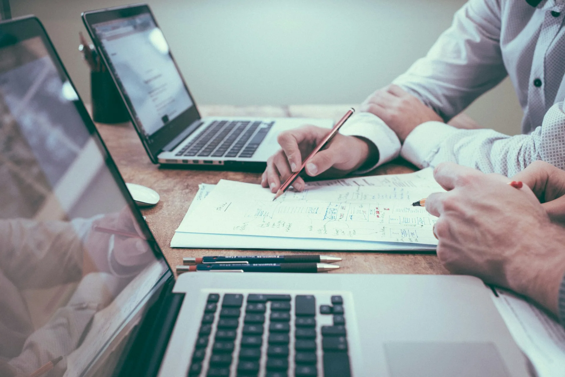 Business professionals reviewing procurement documents