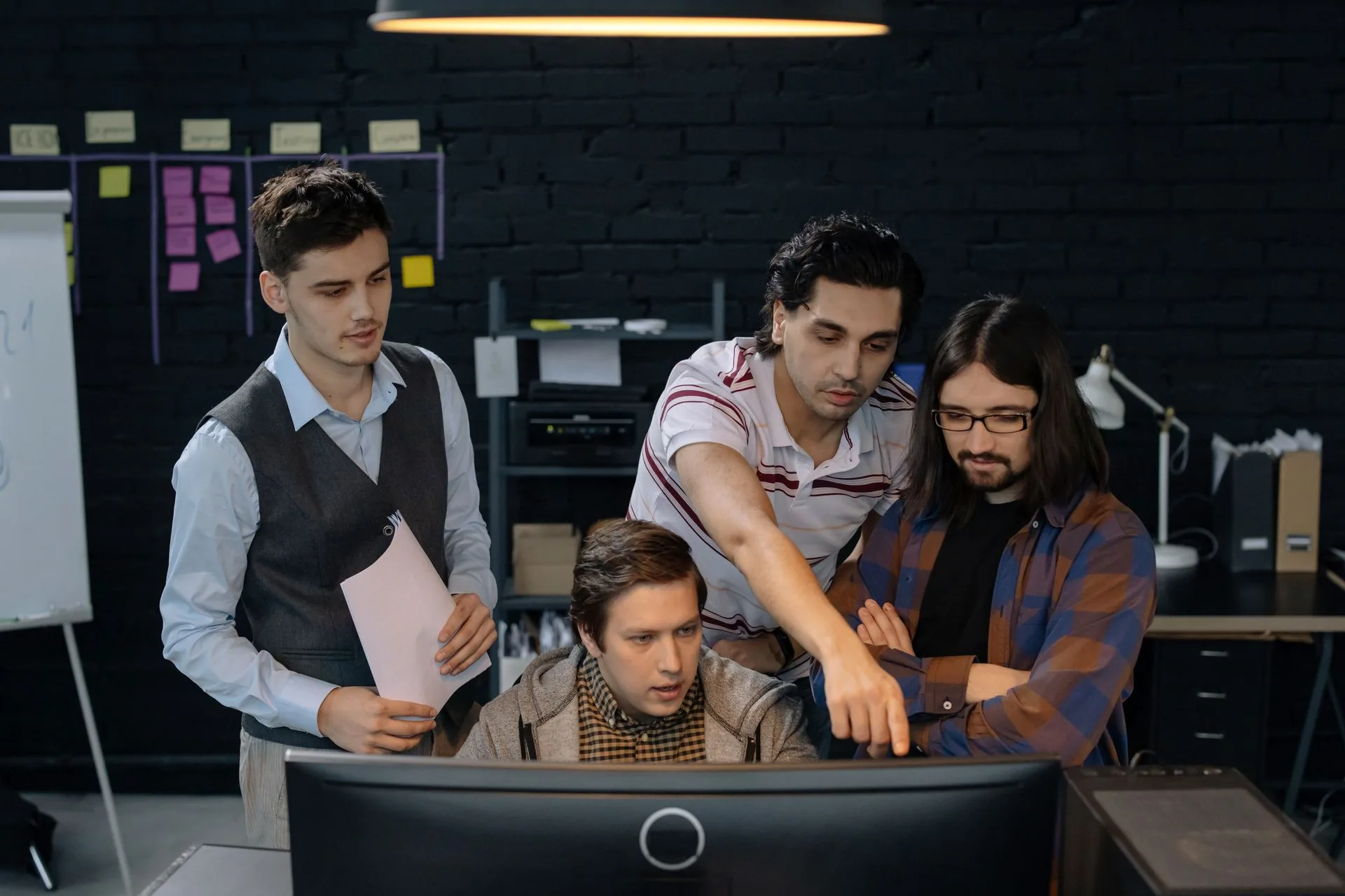 Team discussing a project at a computer